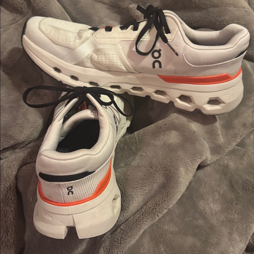 On Running White and Orange Athletic Shoes